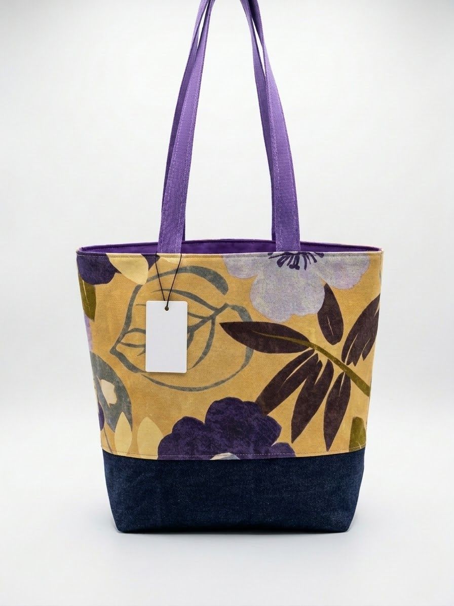 Large tote in a golden botanical print with purple flowers and lavender handles